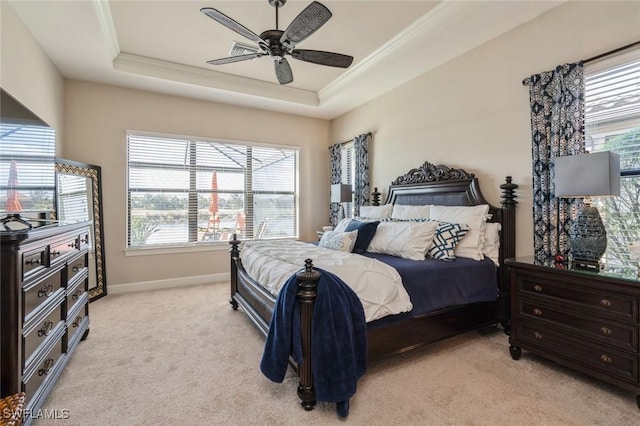 bedroom with ceiling fan, a raised ceiling, and light colored carpet