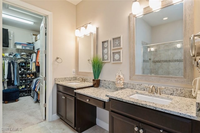 bathroom with vanity, tile patterned flooring, and a shower with door