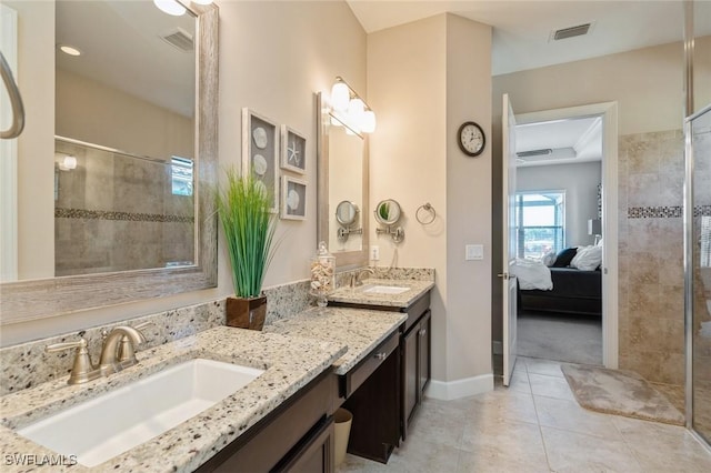 bathroom with tiled shower and vanity