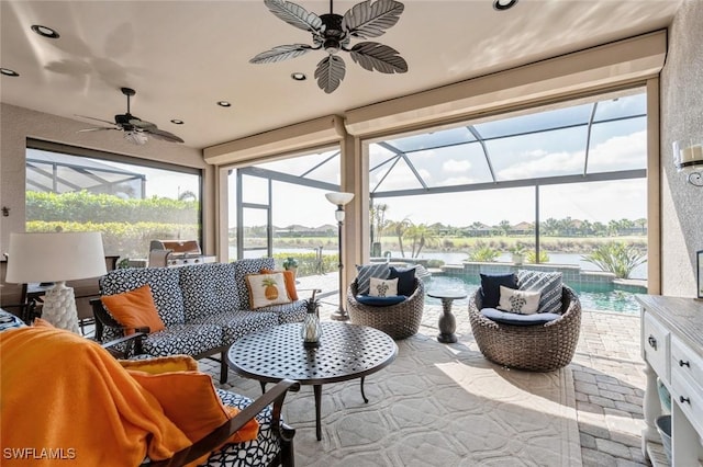 sunroom featuring a water view