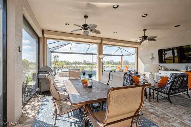 sunroom / solarium featuring ceiling fan and plenty of natural light