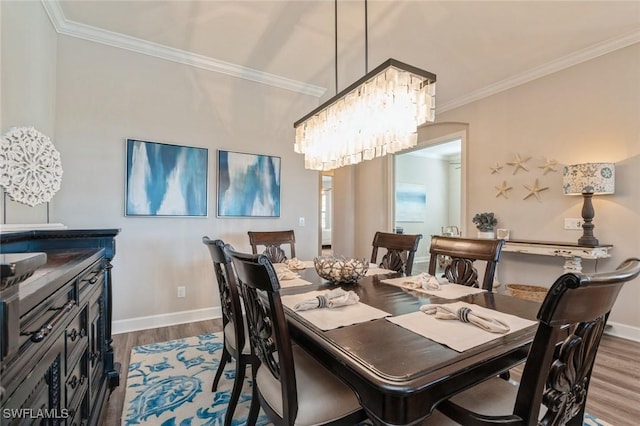 dining room with wood-type flooring, crown molding, and a chandelier