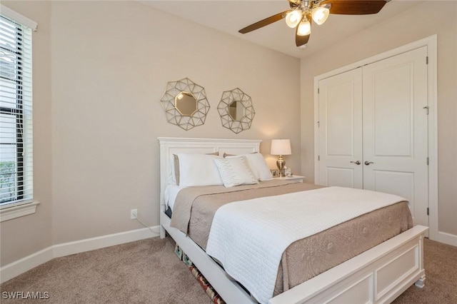 bedroom featuring multiple windows, carpet floors, a closet, and ceiling fan