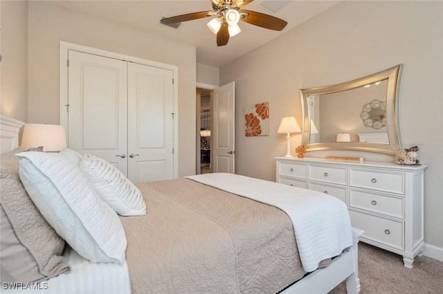 bedroom featuring light colored carpet, a closet, and ceiling fan