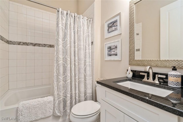 full bathroom with vanity, shower / tub combo, and toilet