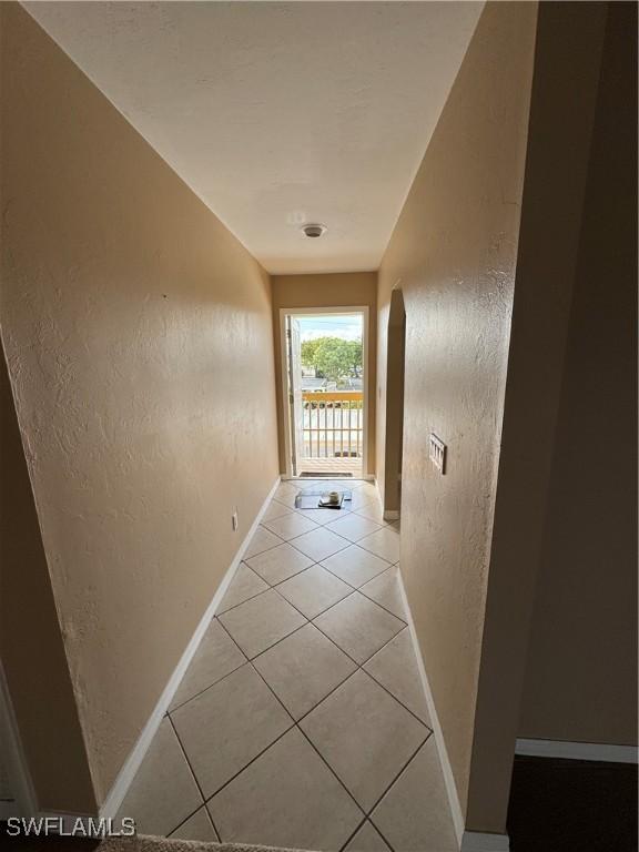 hallway with light tile patterned flooring