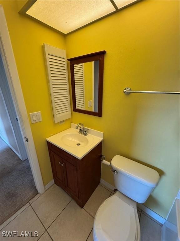 bathroom featuring tile patterned flooring, vanity, and toilet