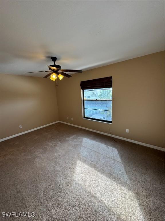 unfurnished room with ceiling fan and carpet floors