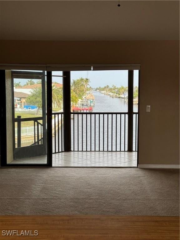 interior space with carpet floors and a water view