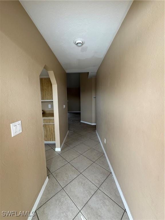 corridor featuring light tile patterned flooring