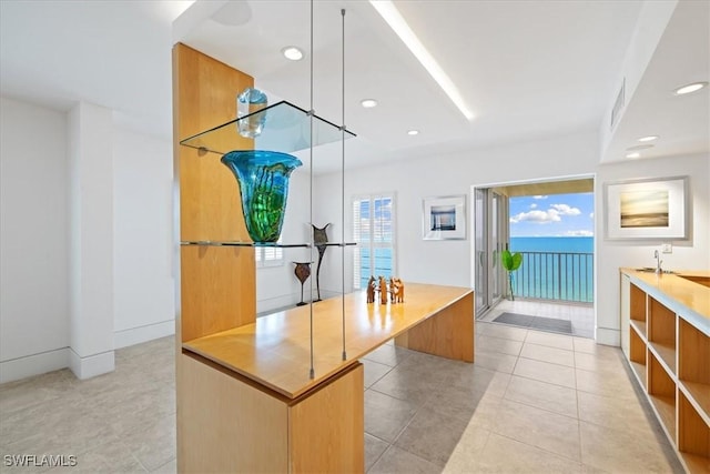 bathroom featuring tile patterned floors and a water view