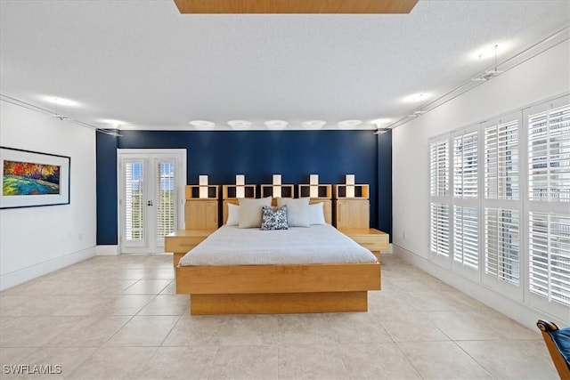 bedroom with access to exterior, multiple windows, and light tile patterned floors