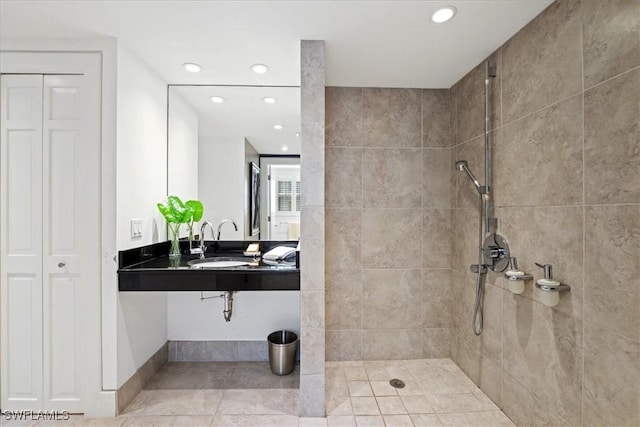 bathroom with sink and tiled shower