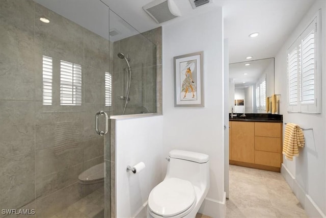 bathroom featuring walk in shower, vanity, tile patterned floors, and toilet