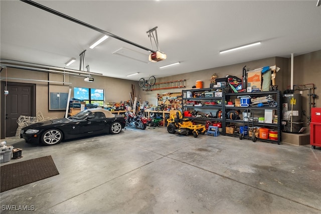 garage with a workshop area, gas water heater, and a garage door opener