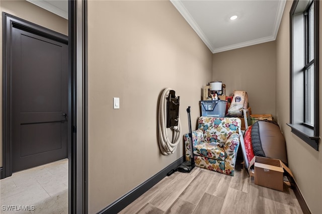 interior space featuring light wood-type flooring and crown molding