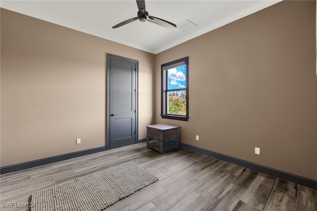 unfurnished room with ceiling fan and crown molding