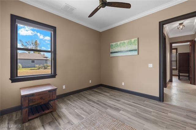 unfurnished room featuring light hardwood / wood-style floors, ceiling fan, and crown molding