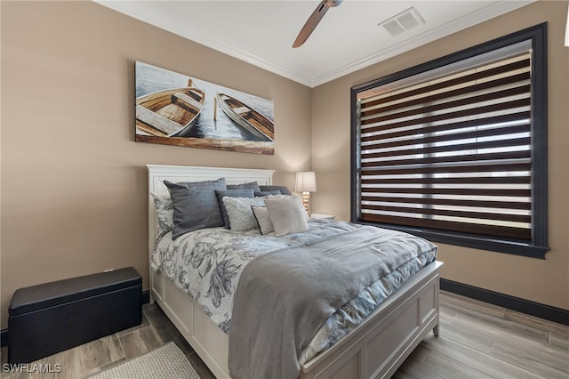 bedroom with ceiling fan and ornamental molding