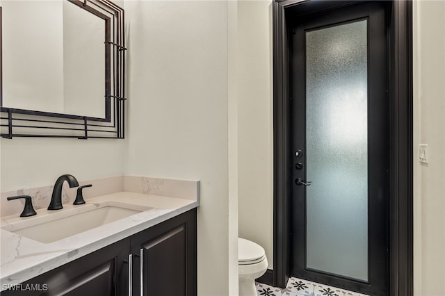 bathroom featuring toilet and vanity