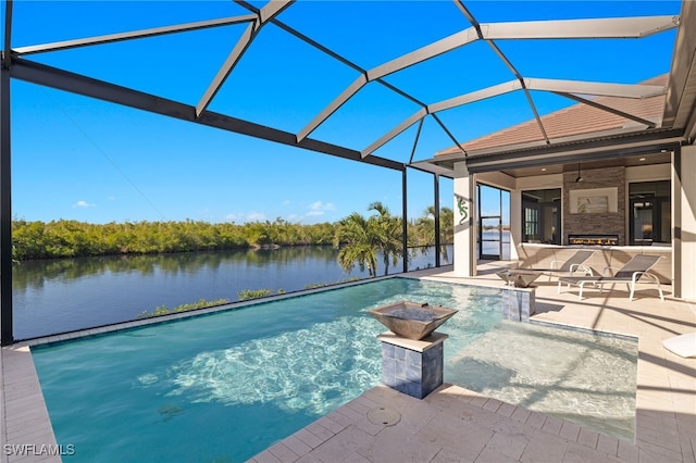 view of pool with a lanai, a water view, and a patio area