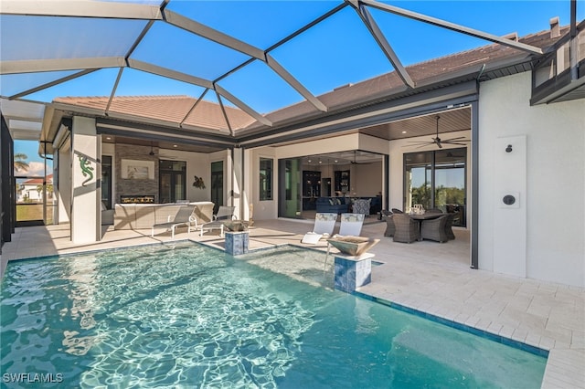 view of swimming pool featuring a lanai, ceiling fan, and a patio