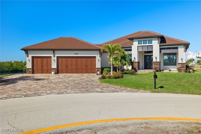 view of front facade with a front lawn and a garage