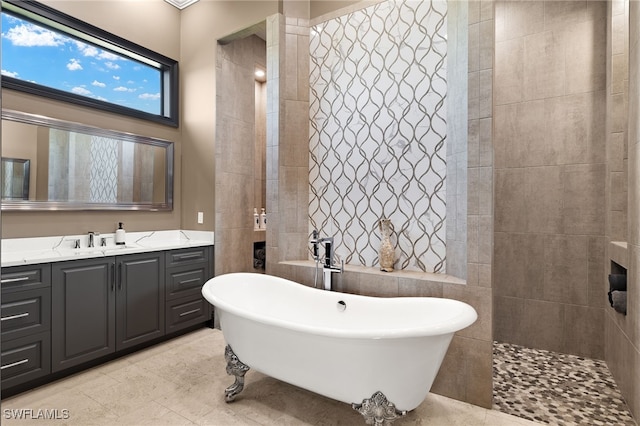 bathroom featuring a towering ceiling, vanity, tile walls, and independent shower and bath