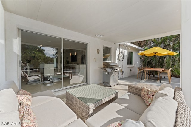 view of patio with an outdoor living space and grilling area