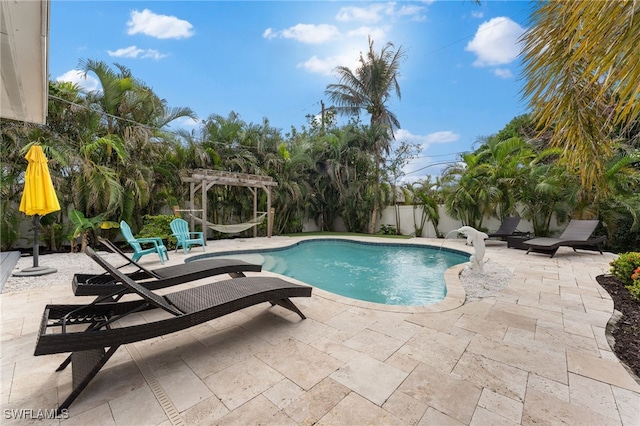 view of pool with a pergola, a patio area, and a fenced backyard