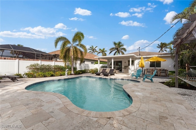 view of swimming pool featuring a patio, fence, and an outdoor hangout area