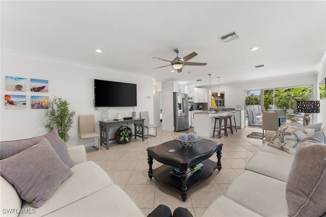 tiled living room with ceiling fan and ornamental molding