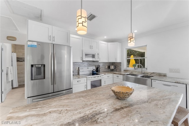 kitchen featuring pendant lighting, white cabinetry, and white appliances