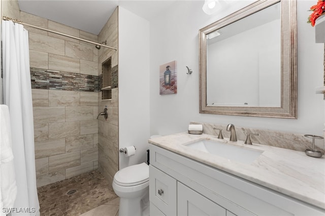 bathroom with a shower with shower curtain, vanity, toilet, and tile patterned floors