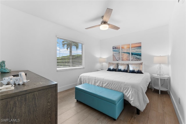 bedroom with light wood-type flooring and ceiling fan