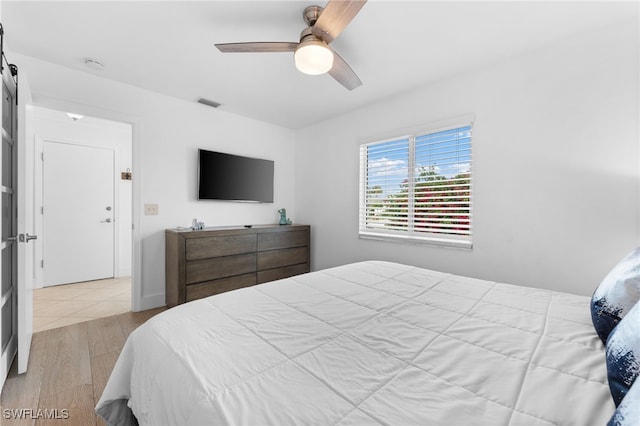 bedroom with ceiling fan and light hardwood / wood-style floors