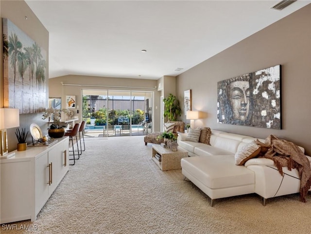 living room featuring lofted ceiling and light colored carpet