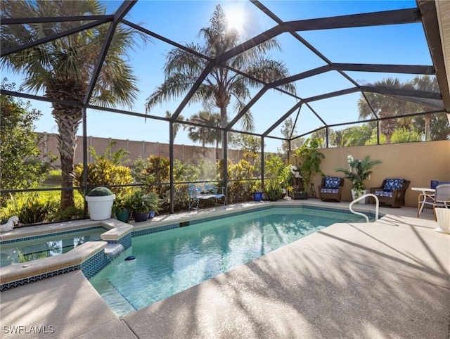 view of pool featuring glass enclosure and a patio