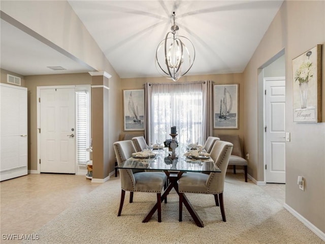 dining room with light tile patterned flooring, a chandelier, and vaulted ceiling