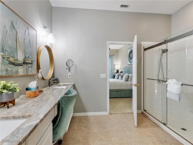 bathroom with tile patterned floors, a shower with shower door, and vanity