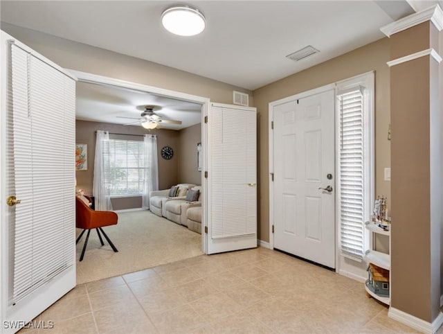 carpeted foyer entrance with ceiling fan