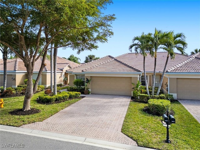 view of front of property with a front yard and a garage