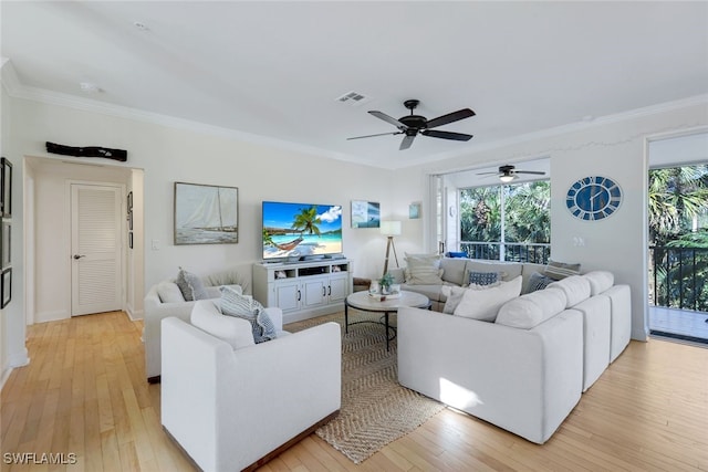 living room featuring crown molding, ceiling fan, and light hardwood / wood-style floors