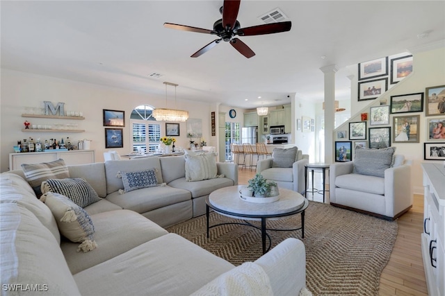 living room with light wood-type flooring and ceiling fan