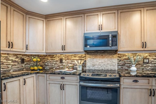 kitchen featuring backsplash, dark stone countertops, light brown cabinets, and stainless steel appliances