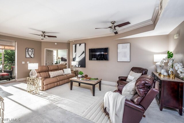 living room with ceiling fan and ornamental molding