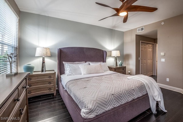 bedroom featuring a closet, ceiling fan, and dark wood-type flooring