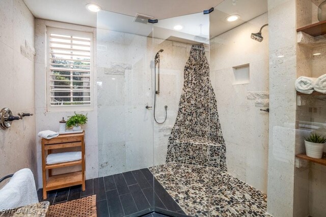 bathroom featuring a tile shower