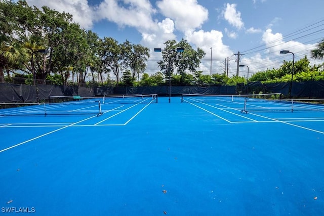 view of tennis court featuring basketball court