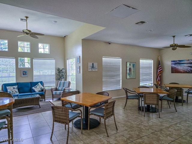 tiled dining space with ceiling fan